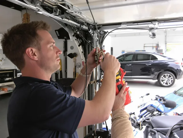 Hilliard Garage Door Repair safety certified technician performing cable replacement in Hilliard